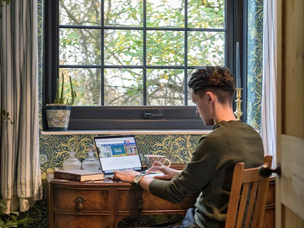 A man typing on his laptop