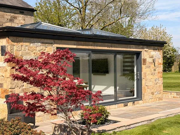 Stone Orangery Extension with Triple Sliding Patio Doors